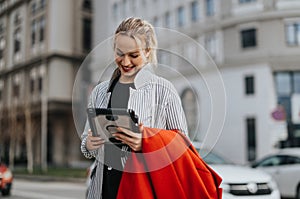 Young businesswoman using tablet with colleague during outdoor meeting in urban setting