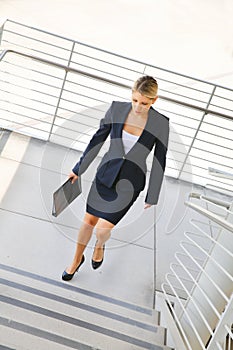 Young businesswoman walking on stairs