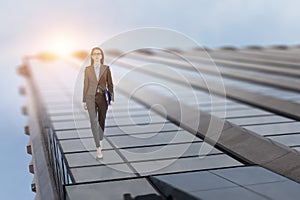 Young businesswoman walking towards success