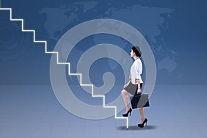 Young businesswoman walking up on stairs