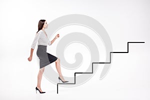 Young businesswoman walking up on stairs