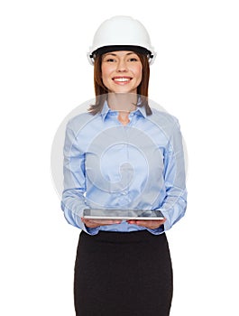 Young businesswoman in white helmet with tablet pc