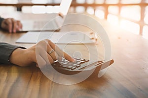 Young businesswoman working with calculator, business document a