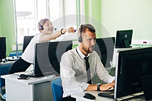 Young businesswoman working in a call center with his colleagues