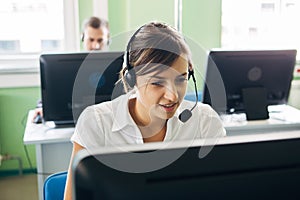 Young businesswoman working in a call center with his colleagues