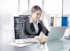 Young businesswoman working with laptop in office