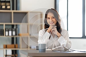 Young businesswoman working on laptop in office