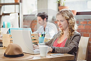 Young businesswoman working on laptop in office