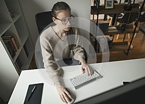 Young businesswoman working long hours from home office