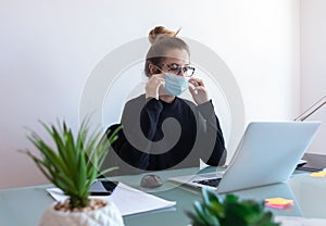 Young businesswoman working with mask