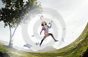 Young businesswoman yelling over megaphone