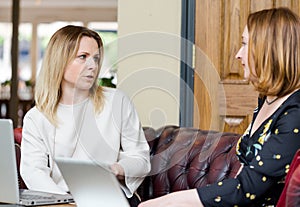 Young businesswomen having conversation at informal meeting