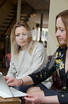 Young businesswomen having conversation at informal meeting