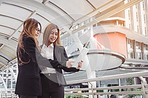 Young Businesswomen using tablet computer at city