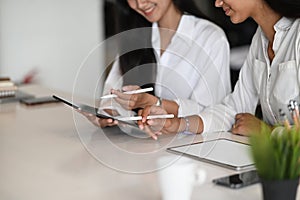 Young businesswomen working their business strategy together with digital tablet at office.