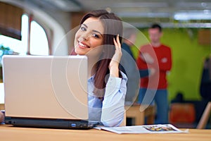 Young busineswoman sitting in the office with laptop