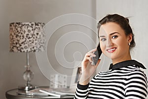 Young bussinesswoman sitting at home and talking with her collegues from work.