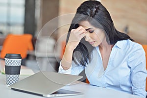 Young busy beautiful latin business woman suffering stress working at office computer