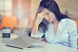 Young busy beautiful latin business woman suffering stress working at office computer