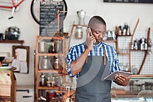 Young cafe owner hard at work in his trendy cafe