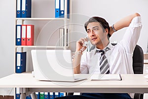 The young call center operator speaking on phone