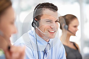 Young call centre operator helping customer