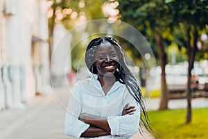 Young calm black skin girl smiles on the street