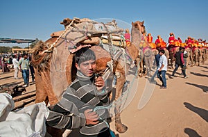 Young cameleer keeps a tight rein on camel