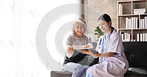 Young caregiver helping senior woman walking. Nurse assisting her old woman patient at nursing home. Senior woman with