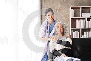 Young caregiver helping senior woman walking. Nurse assisting her old woman patient at nursing home. Senior woman with