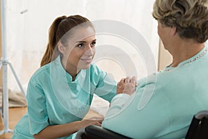 Young caregiver in nursing home photo