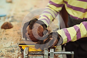 Young carpenter working in craft workshop. Creative student doing his project in workshop. Boy in the workshop makes crafts with