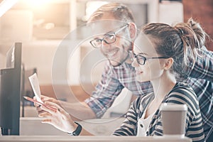 Young Casual business couple using computer in the office. Two colleagues working together on an innovative product design