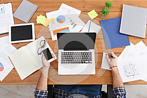 Young casual businessman in office, view from above