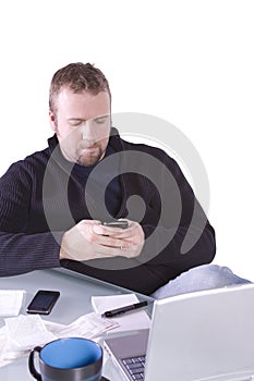 Young Casual Businessman Texting at his Desk