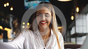 Young casual businesswoman arm on desk rest pose with laptop computer and listening music via headphone and think about