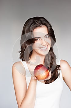 Young casual caucasian girl with red apple