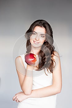 Young casual caucasian girl with red apple