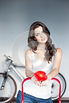 Young casual caucasian girl with red flower