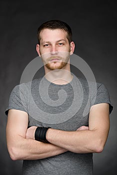 Young casual dressed student man with arms crossed