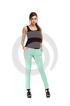 Young casual fashion beautiful girl standing in studio