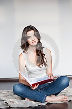 Young casual female holding red book