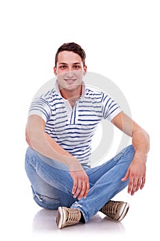 Young casual happy man seated