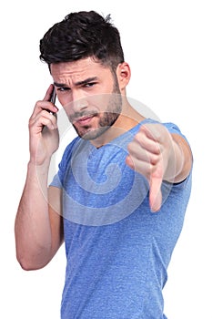Young casual man with bad news on the phone