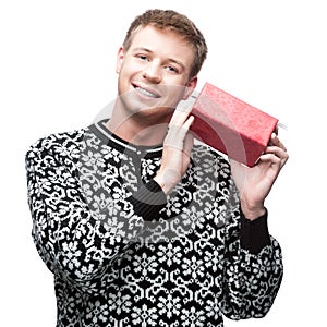 Young casual man hoding christmas gift