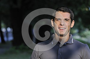 Young casual man outdoor portrait smiling