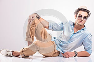 Young casual man resting on the floor