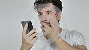 Young Casual Man in Shock while Using Smartphone