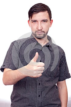 Young casual man showing the thumb up gesture