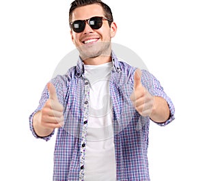 Young casual man showing the thumb up gesture